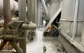 Industrial factory workers inspecting machinery